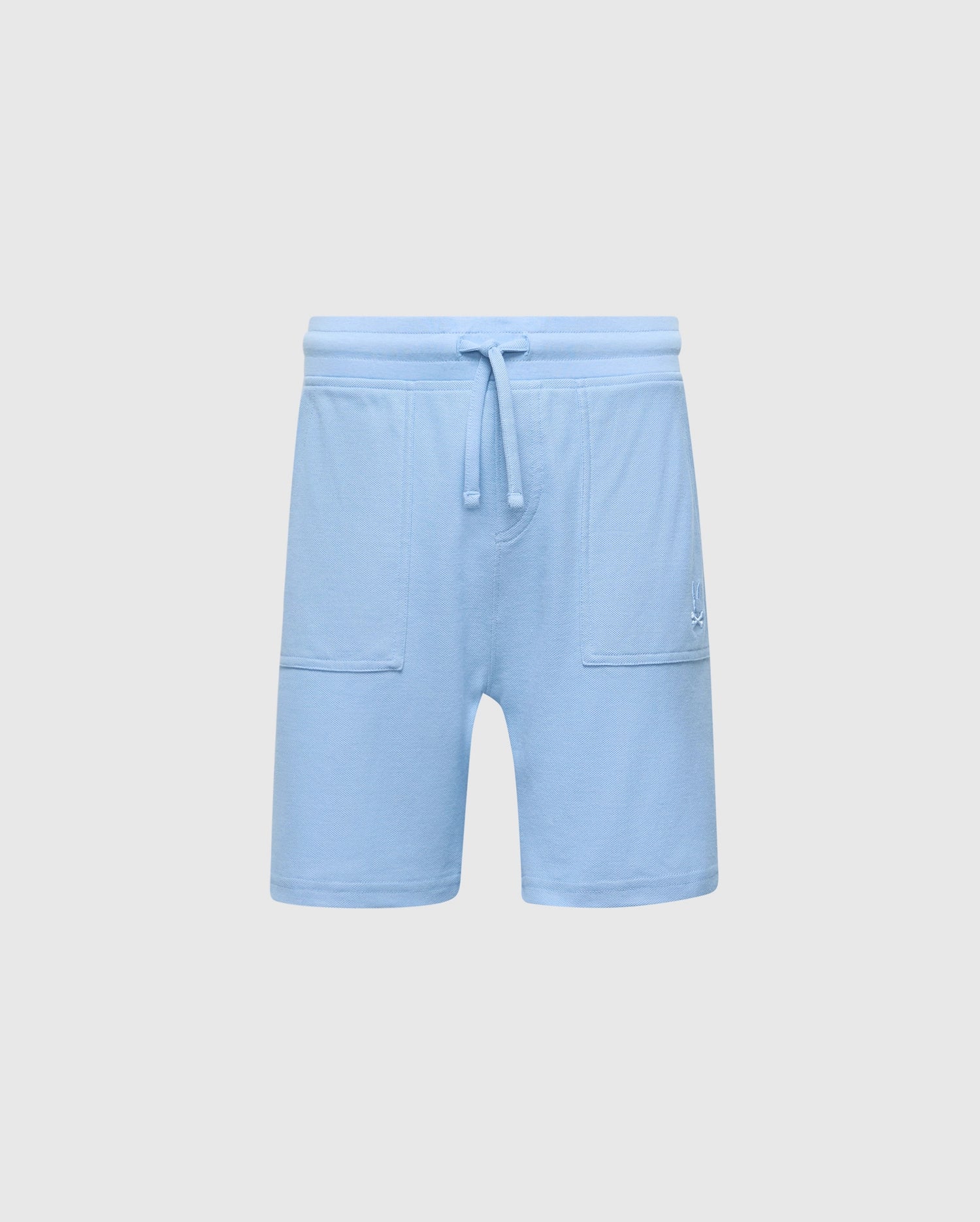 The Psycho Bunny KIDS TAYLOR LIGHT PIQUE SWEATSHORT - B0R344F200 in light blue boasts a drawstring waistband, soft Pima cotton, two front pockets, and an embroidered bunny logo on the left side, offering a casual-chic design perfect for everyday wear.