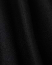 Close-up of a smooth black fabric crafted from luxurious Pima cotton on Psycho Bunny's KIDS HAWAII CITY TEE - B0U169Y1PC, featuring subtle diagonal lines and a soft sheen, evoking the sleek elegance reminiscent of volcanic island landscapes.