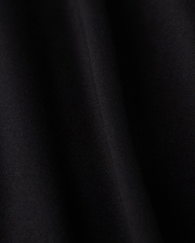 Close-up of a smooth black fabric crafted from luxurious Pima cotton on Psycho Bunny's KIDS HAWAII CITY TEE - B0U169Y1PC, featuring subtle diagonal lines and a soft sheen, evoking the sleek elegance reminiscent of volcanic island landscapes.
