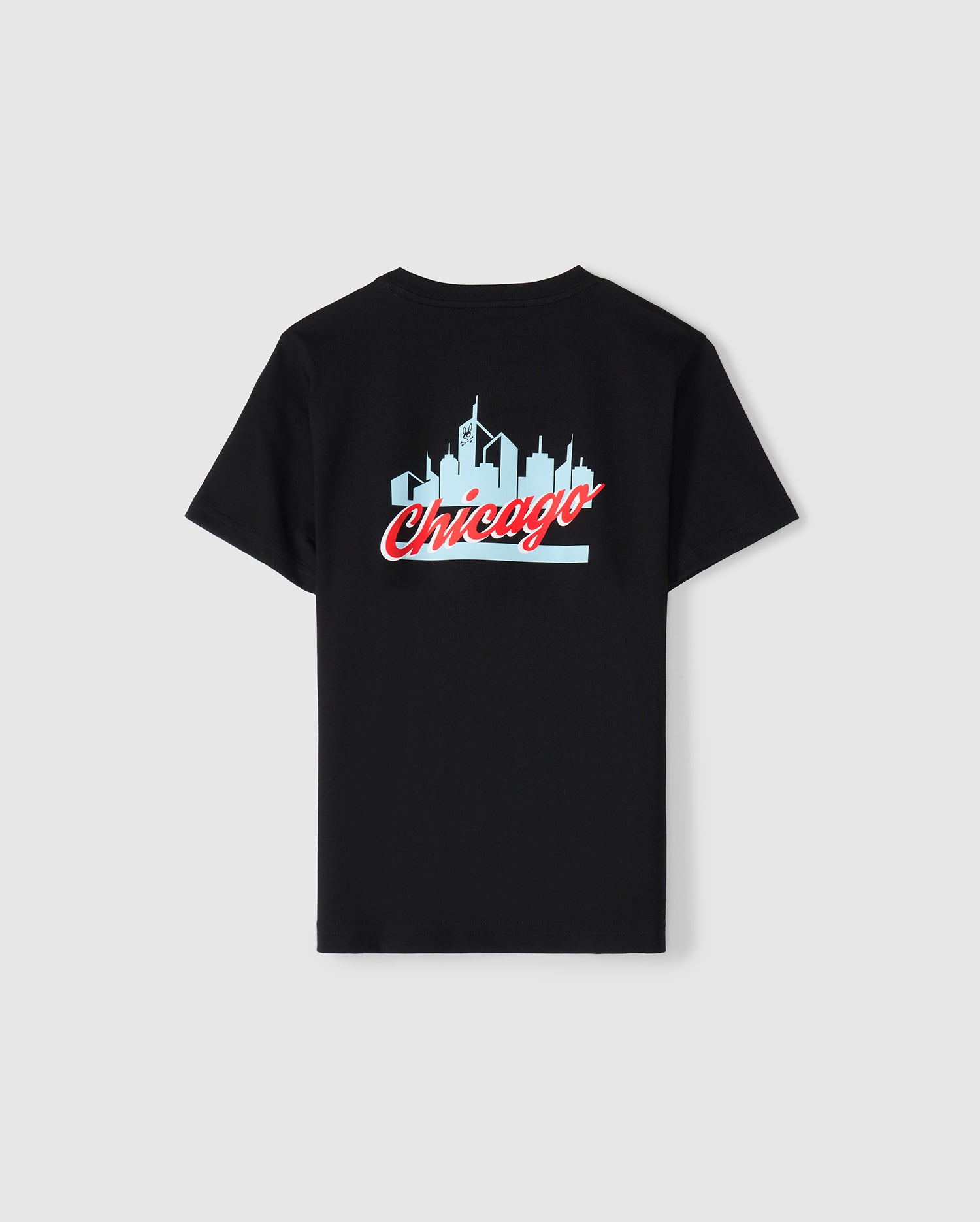 The Kids Chicago City Tee by Psycho Bunny, available in black, is made from soft Pima cotton jersey and showcases a light blue skyline silhouette with "Chicago" prominently written in red cursive below. This eye-catching design is centered on the back of the T-shirt.