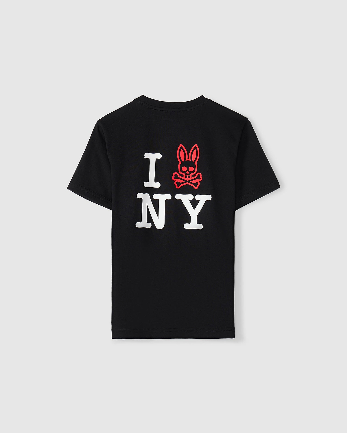 This New York City tee by Psycho Bunny, designed for kids, is crafted from soft Pima cotton and features a unique twist on the classic "I ♥ NY" design. The heart is cleverly replaced with a red skull and crossbones adorned with rabbit ears, all set against a plain background.