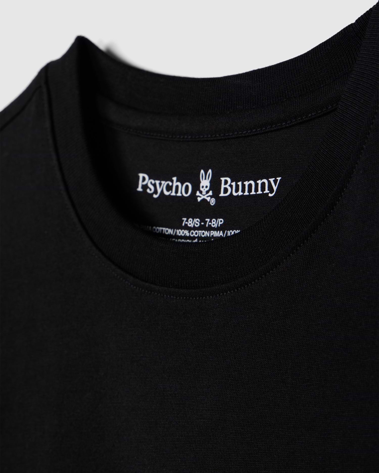 Close-up of a black t-shirt, showcasing the brand name "Psycho Bunny" and a small bunny skull logo inside the collar. Details include shirt size and material info, made from 100% Peruvian Pima cotton. The soft and smooth fabric highlights its premium quality. This particular piece is identified as the "KIDS LOS ANGELES CITY TEE - B0U861A2PC".