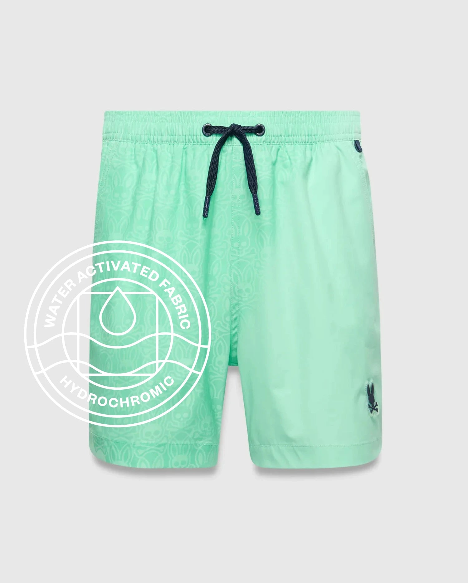 Kids Samos Hydrochromic Printed Swim Trunk in mint green, featuring a subtle hydrochromic bunny skull pattern that appears when wet, dark blue drawstring, and small embroidered Psycho Bunny logo on the left leg.