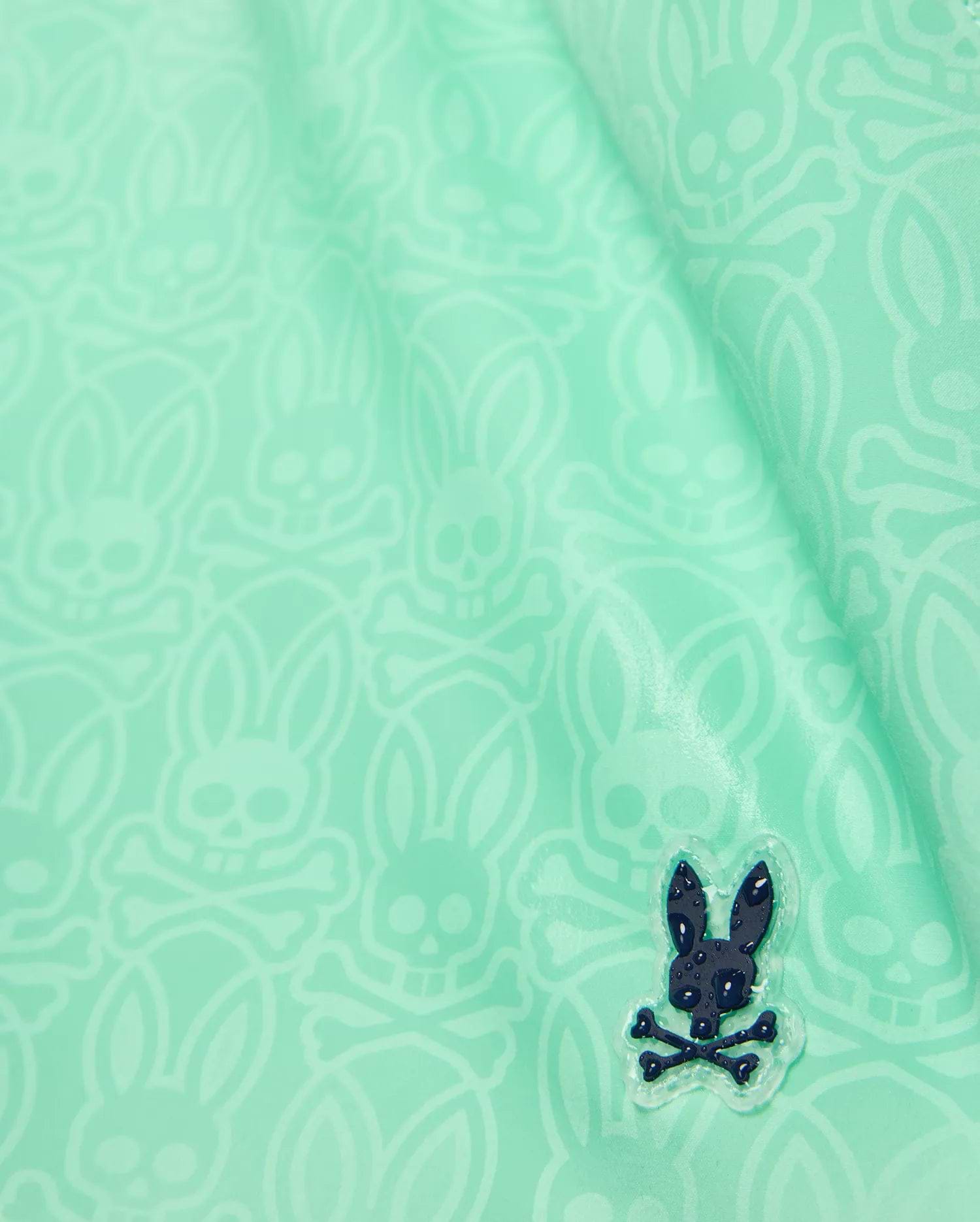 Kids Samos Hydrochromic Printed Swim Trunk in mint green, featuring a subtle all-over tone-on-tone Psycho Bunny skull print and a raised dark navy rubberized bunny logo with water droplets.