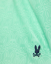 Kids Samos Hydrochromic Printed Swim Trunk in mint green, featuring a subtle all-over tone-on-tone Psycho Bunny skull print and a raised dark navy rubberized bunny logo with water droplets.
