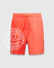 Kids Samos Hydrochromic Printed Swim Trunk in vibrant coral, featuring a water-activated all-over Psycho Bunny skull pattern on the left, solid right leg, and small embroidered bunny logo.