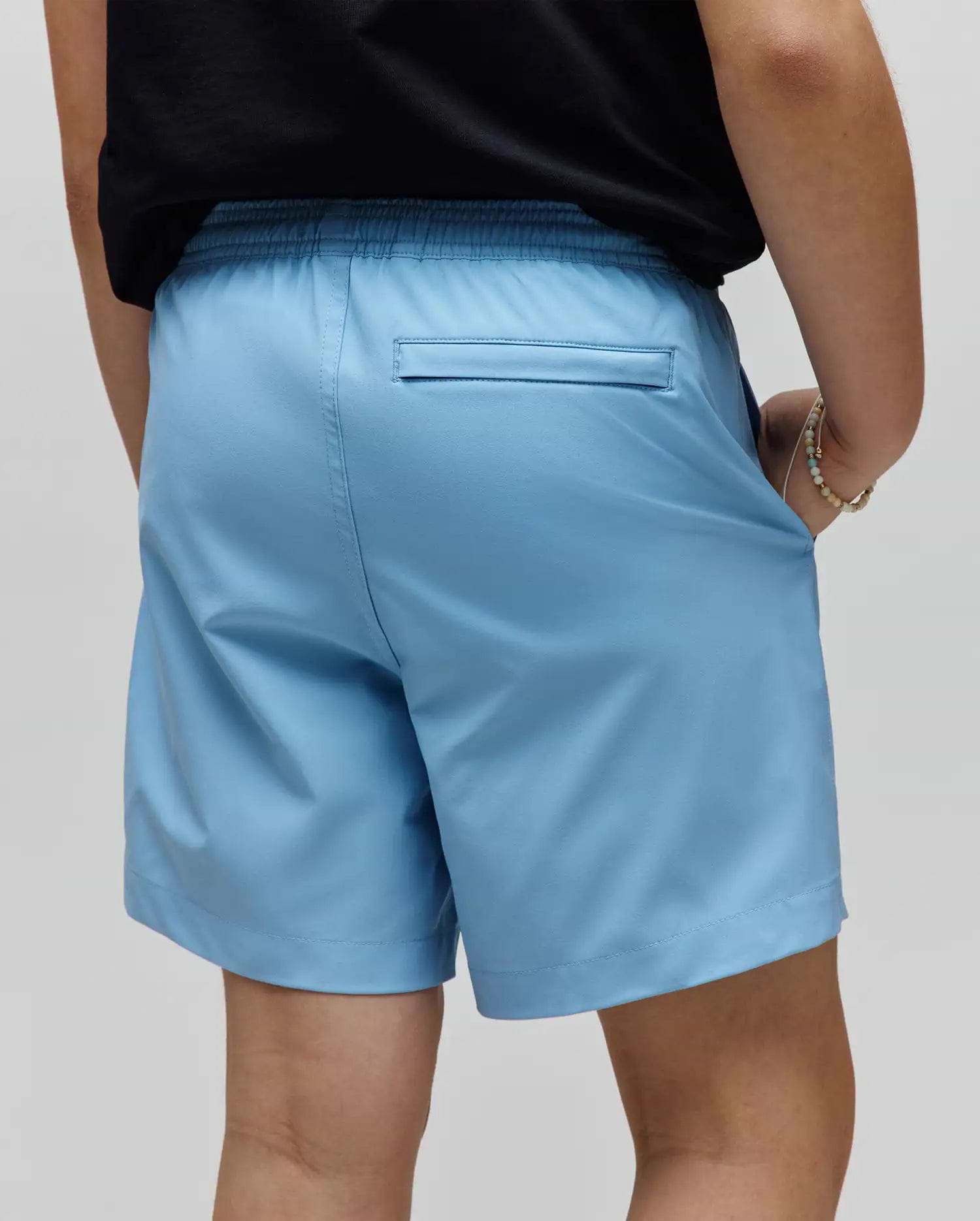 Kids Samos Hydrochromic Printed Swim Trunk in light blue, featuring a relaxed fit, elastic waistband, and a back welt pocket. Smooth, quick-dry fabric.
