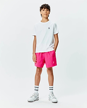 White classic-fit jersey t-shirt with small embroidered Psycho Bunny skull logo on chest, paired with hot pink Kids Samos Hydrochromic Printed Swim Trunk featuring a tonal embroidered bunny skull.