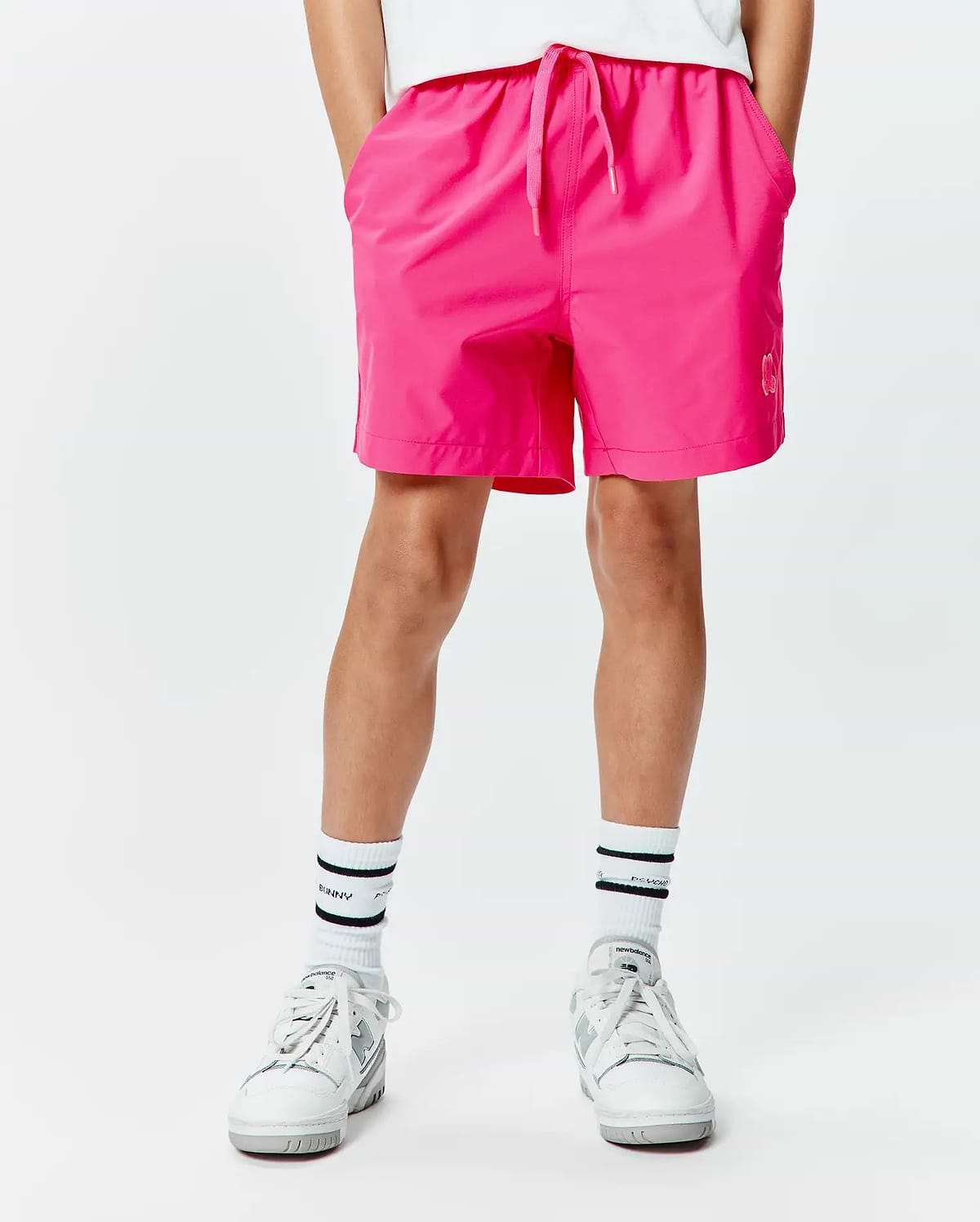 Kids Samos Hydrochromic Printed Swim Trunk in vibrant fuchsia, featuring a relaxed fit, smooth quick-dry fabric, drawstring waist, and a small tonal Psycho Bunny logo on the lower right leg.