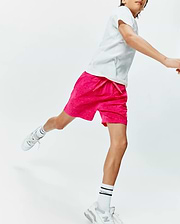 Kids Samos Hydrochromic Printed Swim Trunk in vibrant hot pink, featuring a subtle all-over Psycho Bunny skull pattern, relaxed fit, and a small embroidered logo on the left leg.