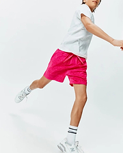 Kids Samos Hydrochromic Printed Swim Trunk in vibrant hot pink, featuring a subtle all-over Psycho Bunny skull pattern, relaxed fit, and a small embroidered logo on the left leg.