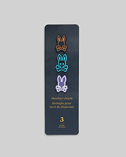 Psycho Bunny Shoe Lace Charms set featuring three iconic bunny skull logos in vibrant orange, blue, and purple, outlined in black, on a dark grey card.