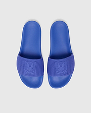 Royal blue MENS KNIT SLIDES with a textured footbed and a knitted strap featuring a large, tonal, signature Psycho Bunny skull logo woven into the fabric.