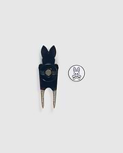 A black Psycho Bunny DIVOT TOOL - B6A699C200 with a bunny-shaped top and a round white magnetic ball marker featuring a pink bunny logo and crossed bones underneath, both placed on a plain white background, makes for perfect golf gifts.