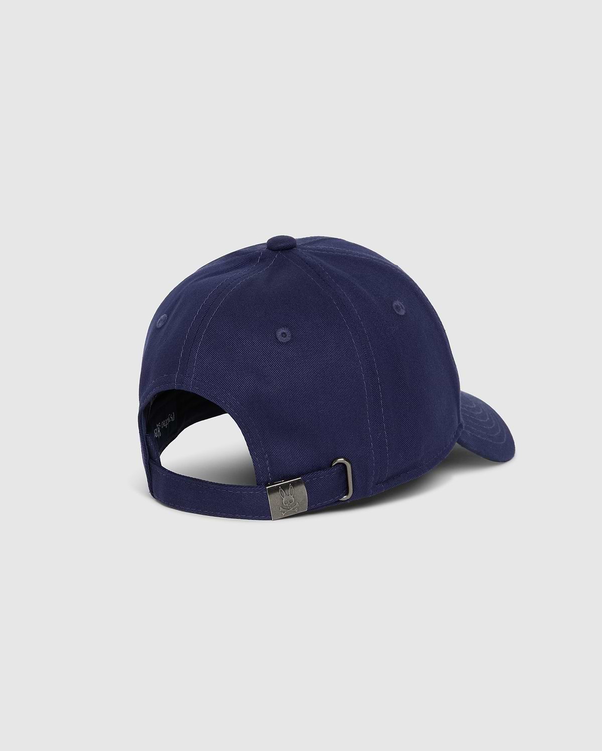A rear view of the Psycho Bunny MENS CLASSIC BASEBALL CAP - B6A816A1HT in navy blue, featuring an adjustable strap with a metal buckle. Made from 100% cotton, this cap is set against a plain, light grey background.