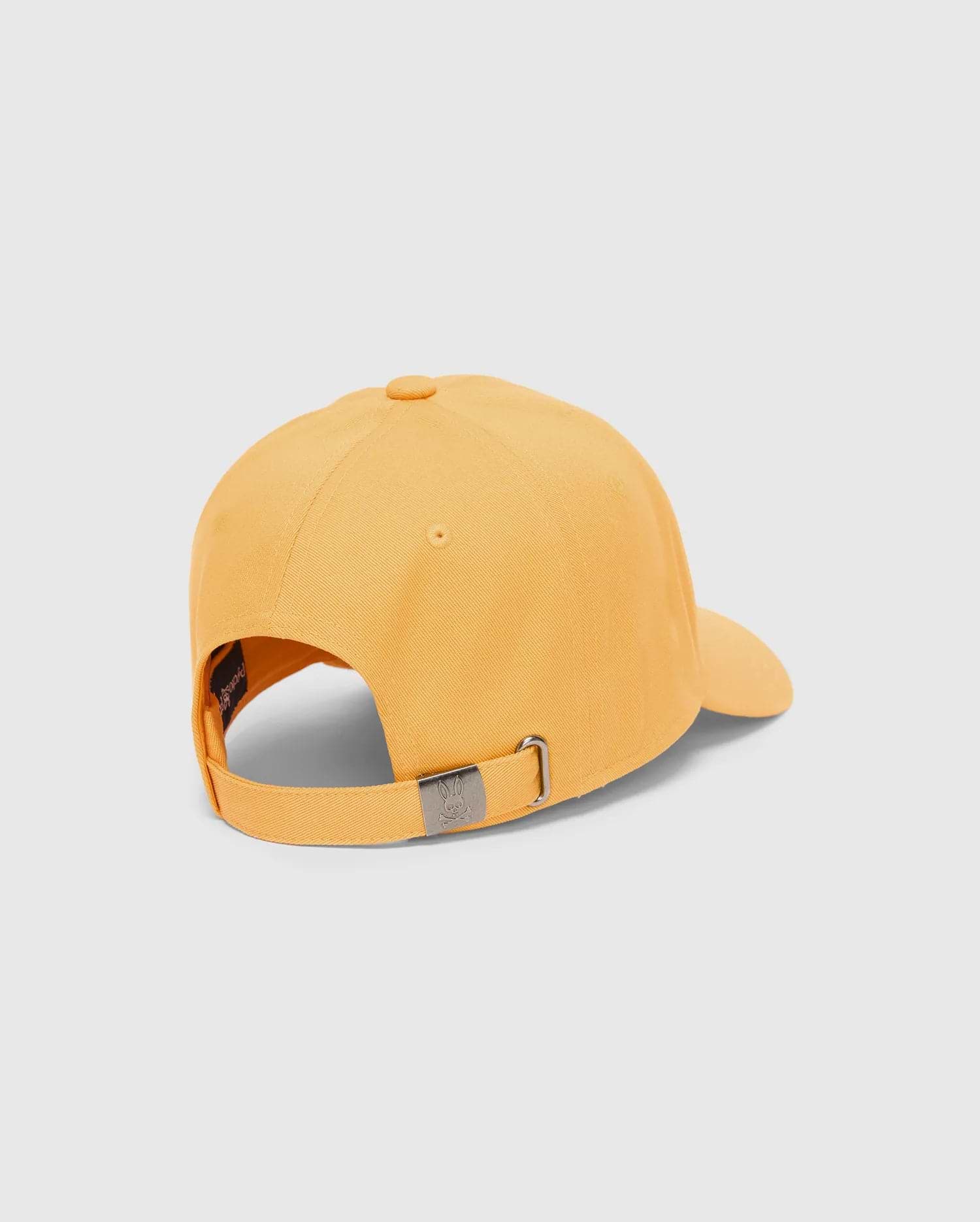Mens Classic Baseball Cap in marigold cotton twill, featuring an adjustable strap with a small engraved Psycho Bunny skull logo on the gunmetal buckle and internal branding.