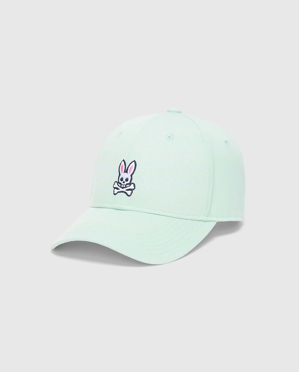Mens Classic Baseball Cap in mint green twill, featuring a classic fit and an embroidered Psycho Bunny skull logo on the front with pink, black, and white details.