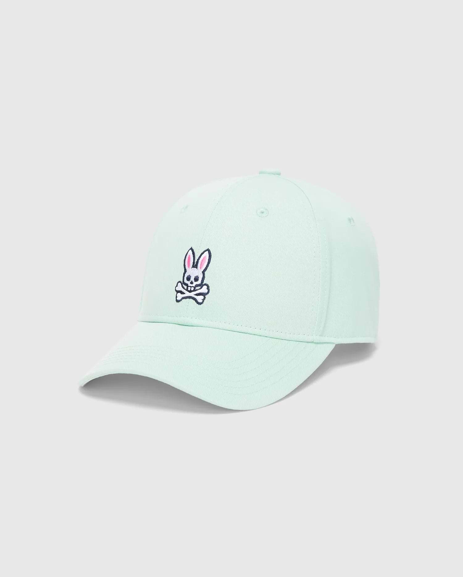 Mens Classic Baseball Cap in mint green twill, featuring a classic fit and an embroidered Psycho Bunny skull logo on the front with pink, black, and white details.