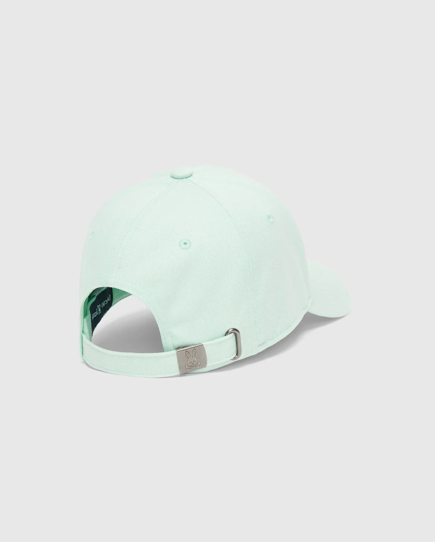MENS CLASSIC BASEBALL CAP in mint green cotton twill, featuring an adjustable strap with a gunmetal buckle engraved with the iconic Psycho Bunny skull logo.