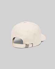 The Psycho Bunny MENS CLASSIC BASEBALL CAP (B6A816A1HT) in beige cotton is shown from the back, highlighting its adjustable metal clasp strap and subtle embroidered bunny logo, set against a plain light gray background.