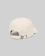 The Psycho Bunny MENS CLASSIC BASEBALL CAP (B6A816A1HT) in beige cotton is shown from the back, highlighting its adjustable metal clasp strap and subtle embroidered bunny logo, set against a plain light gray background.