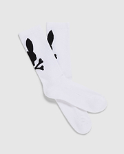 A pack of 3 Men's Sport Socks (B6F997D200) by Psycho Bunny, crafted from luxurious Peruvian Pima cotton in white, features a distinctive black graphic design of a skull with bunny ears and bones. The socks are displayed with one pair slightly overlapping the other on a plain, light-colored background.