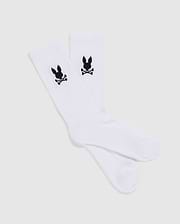A set of 3 MENS 3 PACK SPORT SOCK - B6F997D200 by Psycho Bunny, showcasing a black skull and crossbones with bunny ears design near the top. These luxurious sport socks, crafted from Peruvian pima cotton, are displayed flat against a plain, light-gray background.