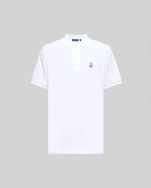 Mens Classic Pique Polo Shirt in crisp white, classic fit, pique knit, with a two-button placket, ribbed collar and cuffs, and a small embroidered pink/purple Psycho Bunny skull logo on the left chest.