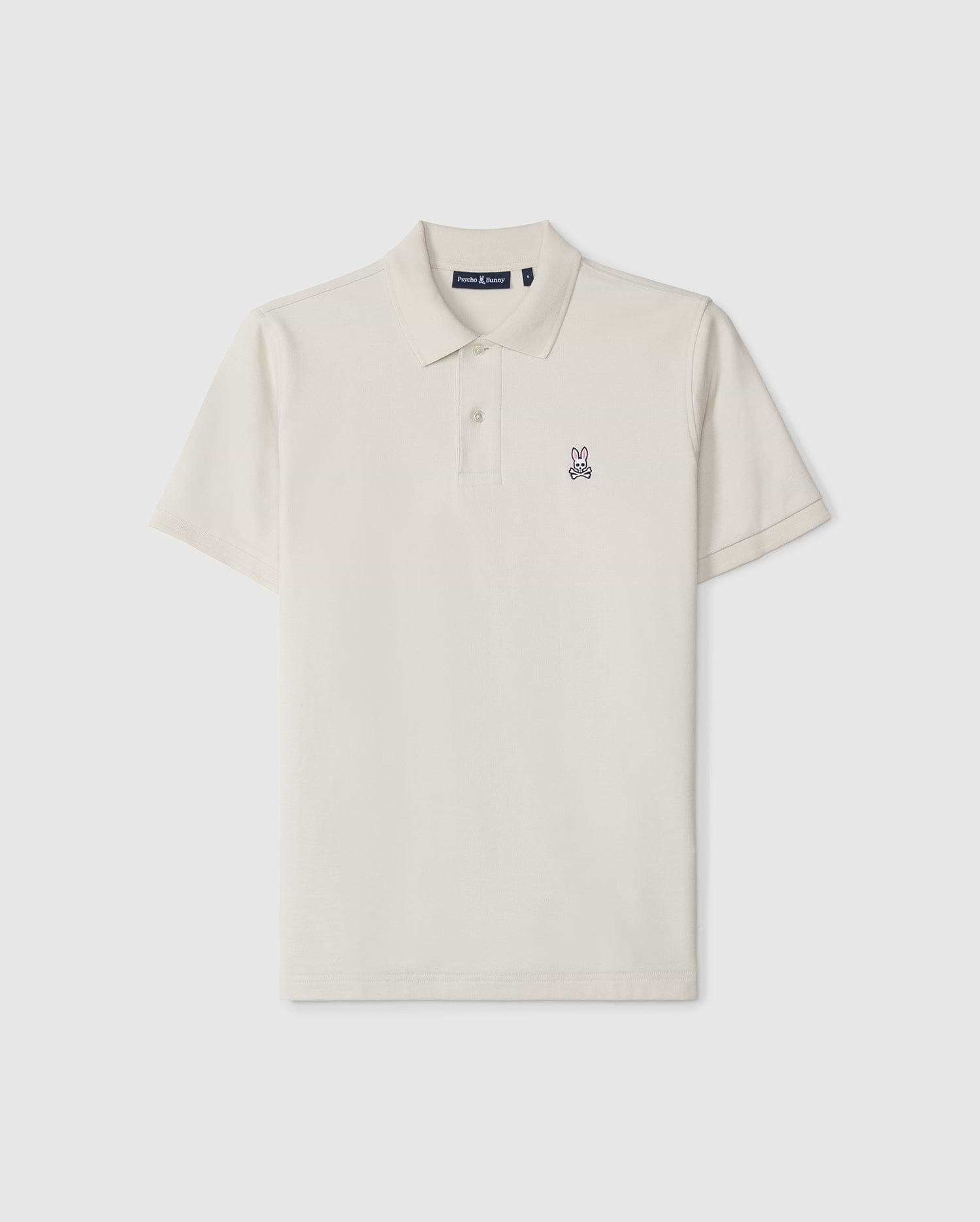 A timeless men's classic pique polo in luxurious Pima cotton, this plain, short-sleeved shirt in off-white features a collar, two buttons, and a small embroidered bunny logo on the left chest. The product is the MENS CLASSIC PIQUE POLO SHIRT - B6K001B200 by Psycho Bunny.