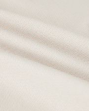 Close-up of a softly folded, light beige textured fabric with a subtle grid pattern, showcasing its smooth and pliable nature. The gentle folds add depth and highlight the luxurious Pima cotton's fine weave and soft sheen, hinting at the perfect fit for a Psycho Bunny Men's Classic Pique Polo Shirt - B6K001B200.