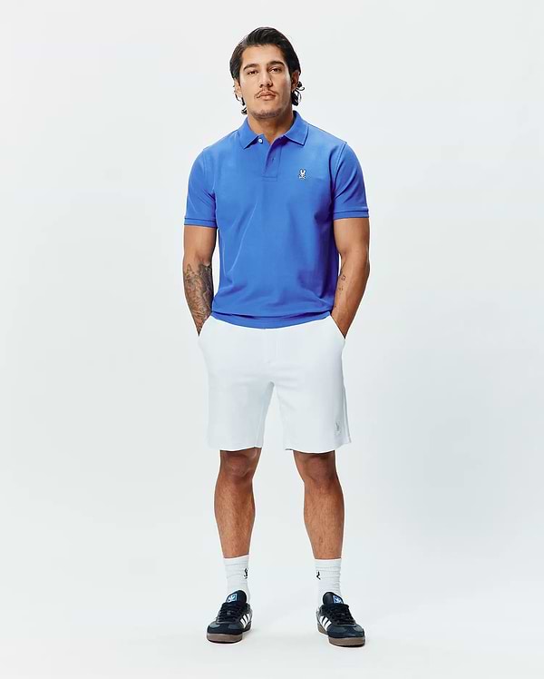 Mens Classic Pique Polo in vibrant royal blue, a classic fit design crafted from textured pique fabric, featuring a small, crisp white embroidered Psycho Bunny skull logo on the left chest.