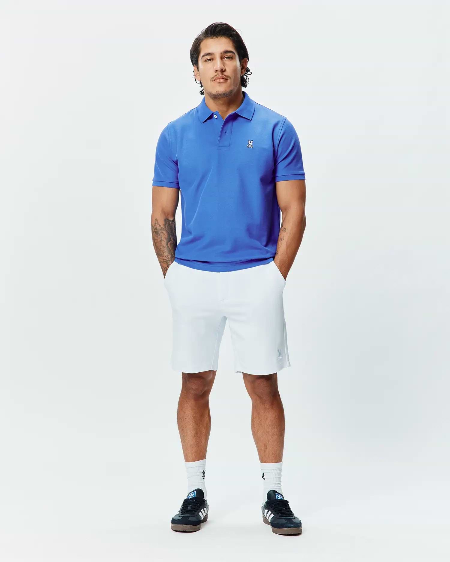 Mens Classic Pique Polo in vibrant royal blue, a classic fit design crafted from textured pique fabric, featuring a small, crisp white embroidered Psycho Bunny skull logo on the left chest.