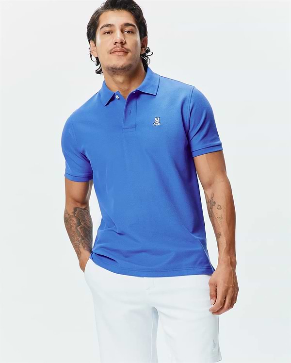 Mens Classic Pique Polo in vibrant royal blue, featuring a classic fit and textured pique knit. Small white embroidered Psycho Bunny skull logo on the left chest.