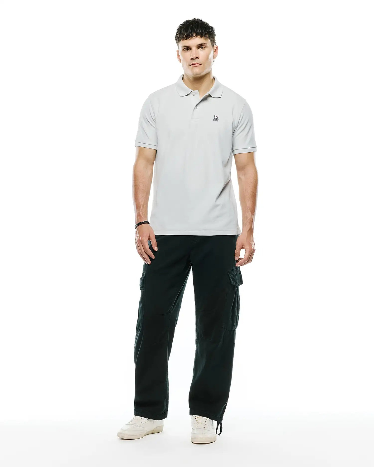 MENS CLASSIC PIQUE POLO in light grey, a classic fit with pique texture and a small black embroidered Psycho Bunny skull logo on the left chest.