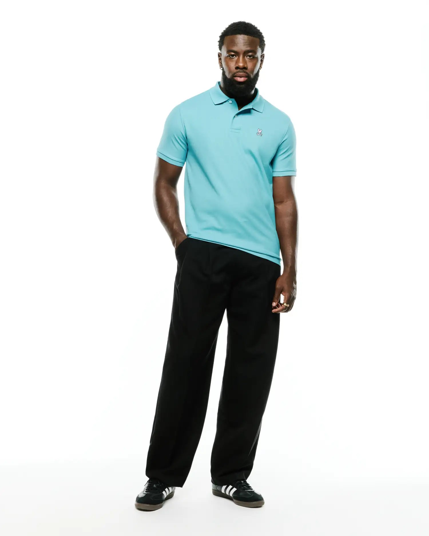 Men's Classic Pima Pique Polo in vibrant aqua blue, crafted from textured pique fabric with a classic fit, featuring a small, intricately embroidered white Psycho Bunny skull logo on the left chest. (5)