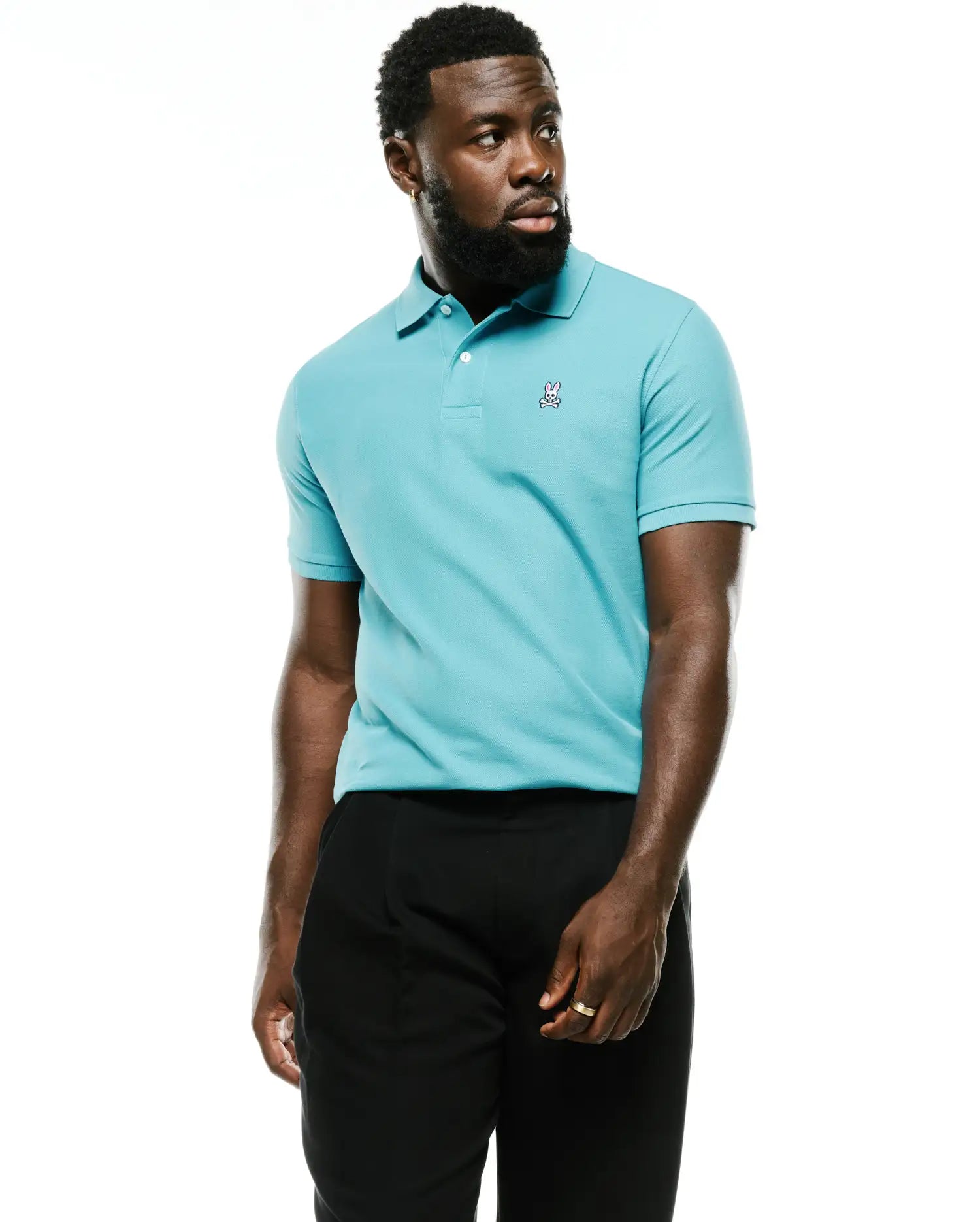 Men's Classic Pima Pique Polo in vibrant aqua blue, featuring a classic fit, textured pique knit, two-button placket, and a small embroidered white Psycho Bunny skull logo on the left chest. (2)