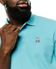 Men's Classic Pima Pique Polo in vibrant aqua, featuring a classic fit, textured pique fabric, and a small embroidered Psycho Bunny skull and crossbones logo with pink ears on the left chest. (3)