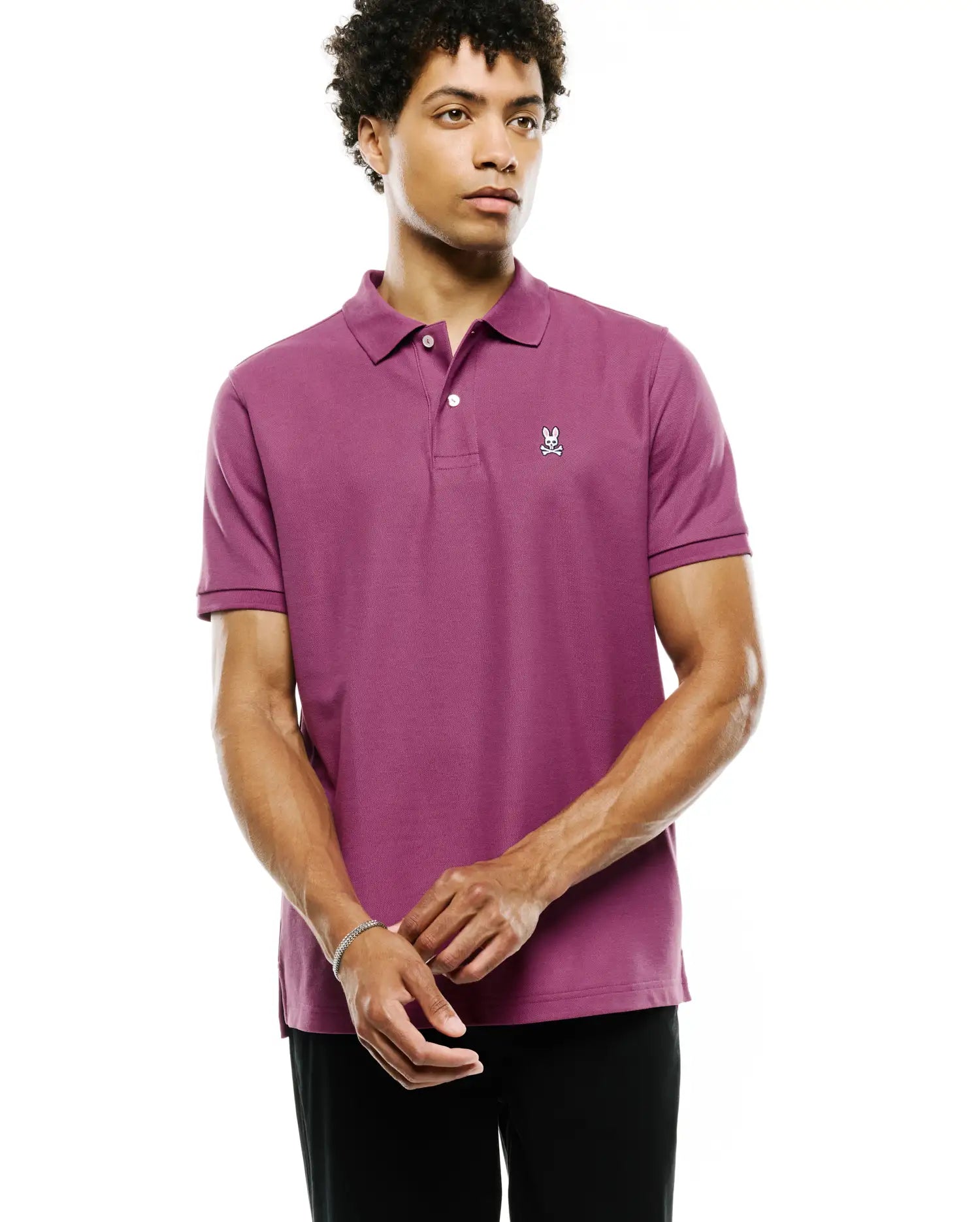 Mens Classic Pique Polo in vibrant magenta, featuring a classic fit, textured pique knit, and a small embroidered white Psycho Bunny skull logo on the left chest.