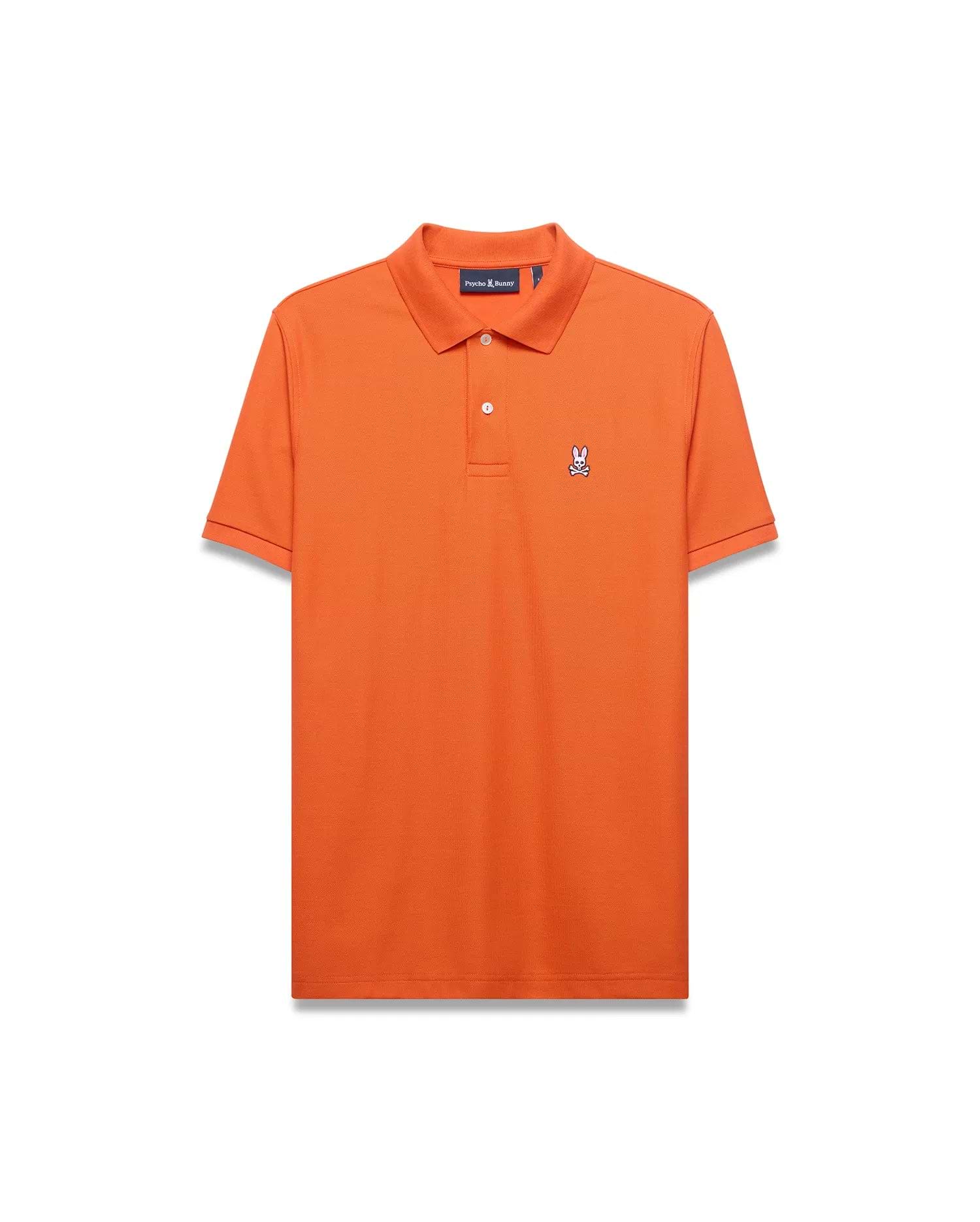 Men's Classic Pima Pique Polo in vibrant orange, featuring a classic fit, textured pique fabric, and a small embroidered white and black Psycho Bunny skull logo on the left chest with white buttons. (5)