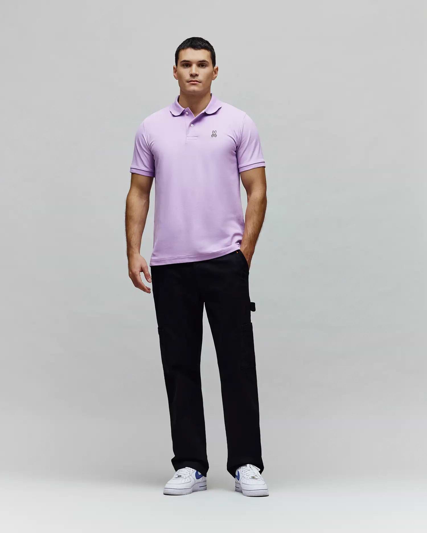 Mens Classic Pique Polo in lavender, crafted from textured pique fabric with a classic fit, featuring a small embroidered black and white Psycho Bunny skull logo on the left chest. (5)