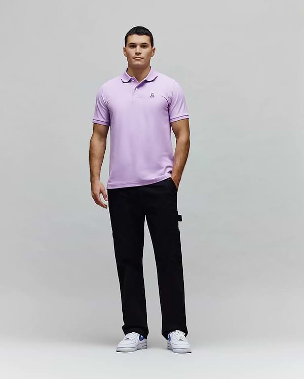 Mens Classic Pique Polo in lavender, crafted from textured pique fabric with a classic fit, featuring a small embroidered black and white Psycho Bunny skull logo on the left chest. (5)