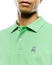 Mens Classic Pique Polo in light green, featuring a classic fit, pique knit texture, two white buttons on the placket, and a small, embroidered pink, white, and black Psycho Bunny skull logo on the left chest. (4)