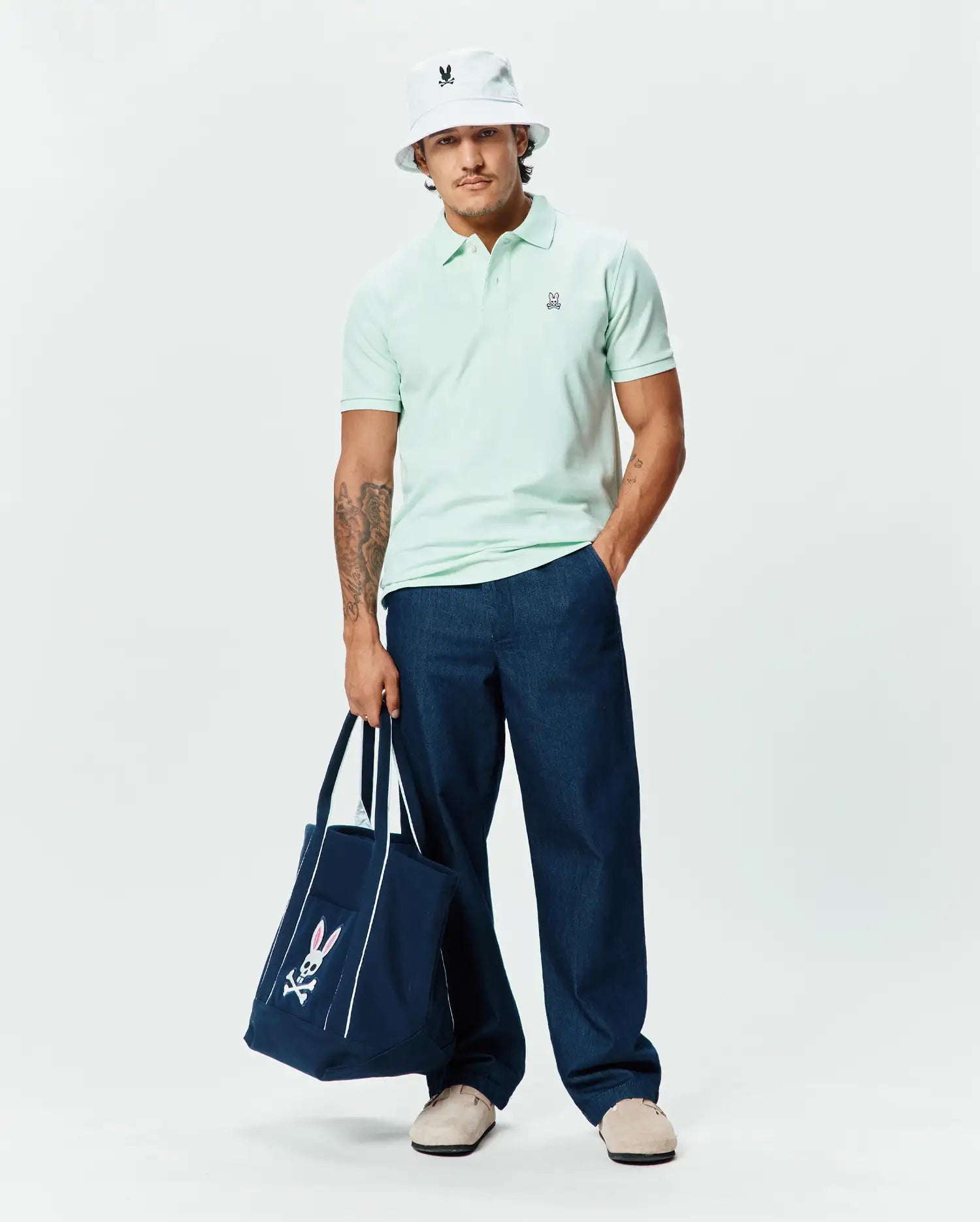 Mens Classic Pique Polo in pale mint green, featuring a classic fit and textured pique fabric, with a small embroidered black and white Psycho Bunny skull logo with pink ears on the left chest. (5)