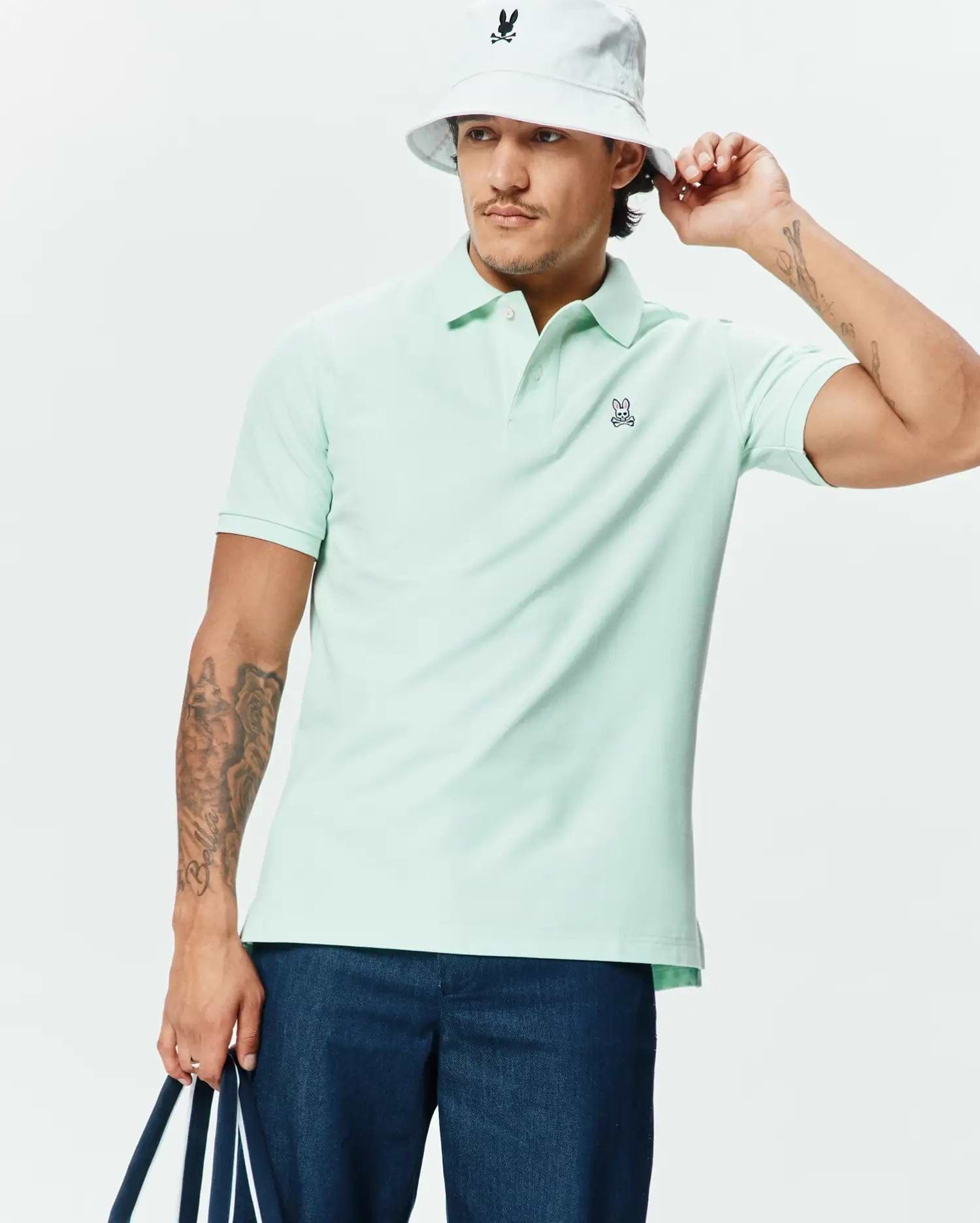 Premium mint green Mens Classic Pique Polo, designed with a classic fit and featuring a small, embroidered Psycho Bunny skull logo on the left chest. (1)