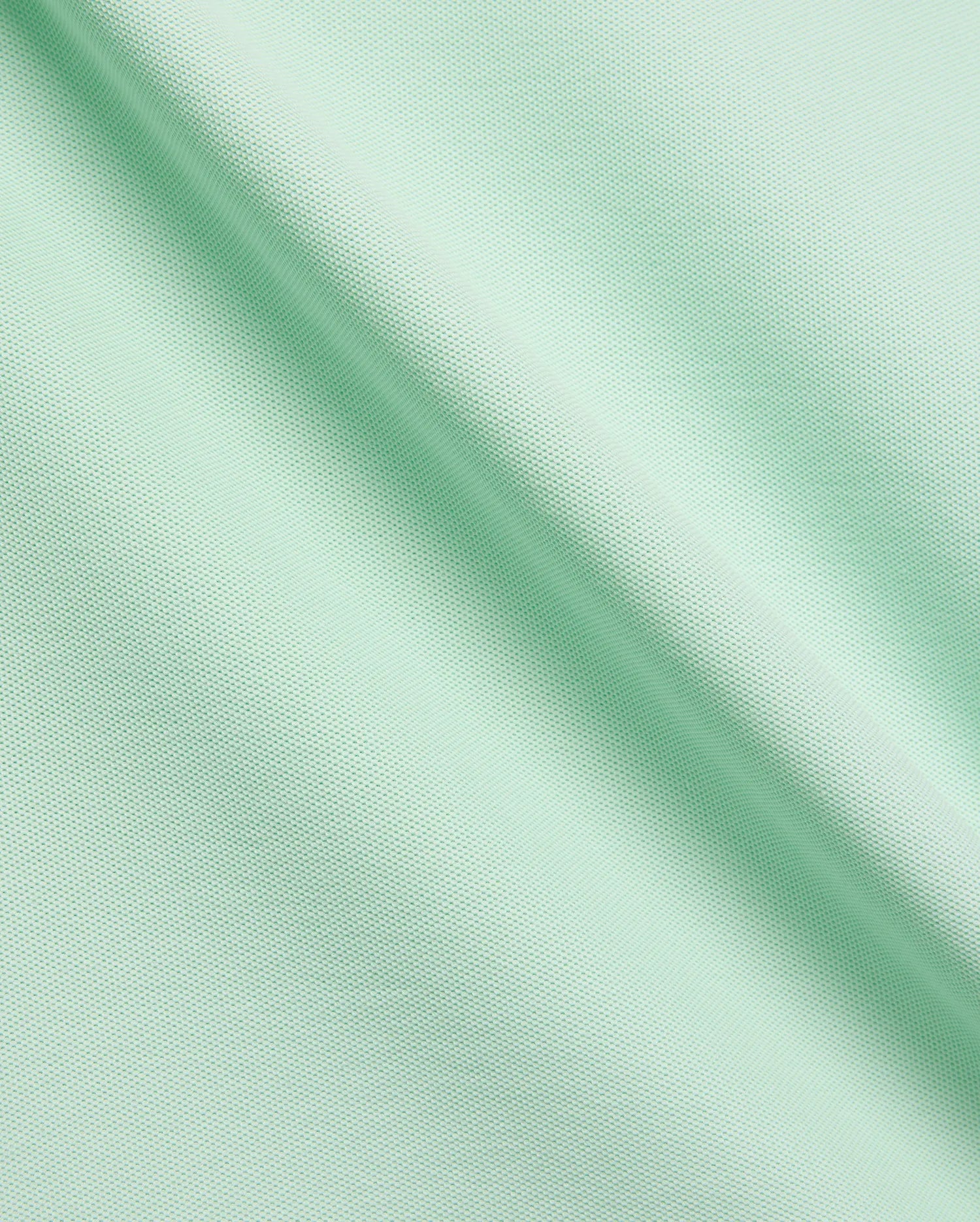 Vibrant Mint Green MENS CLASSIC PIQUE POLO fabric, showcasing its distinctive textured pique knit, soft drape, and premium quality, ideal for refined streetwear. (6)