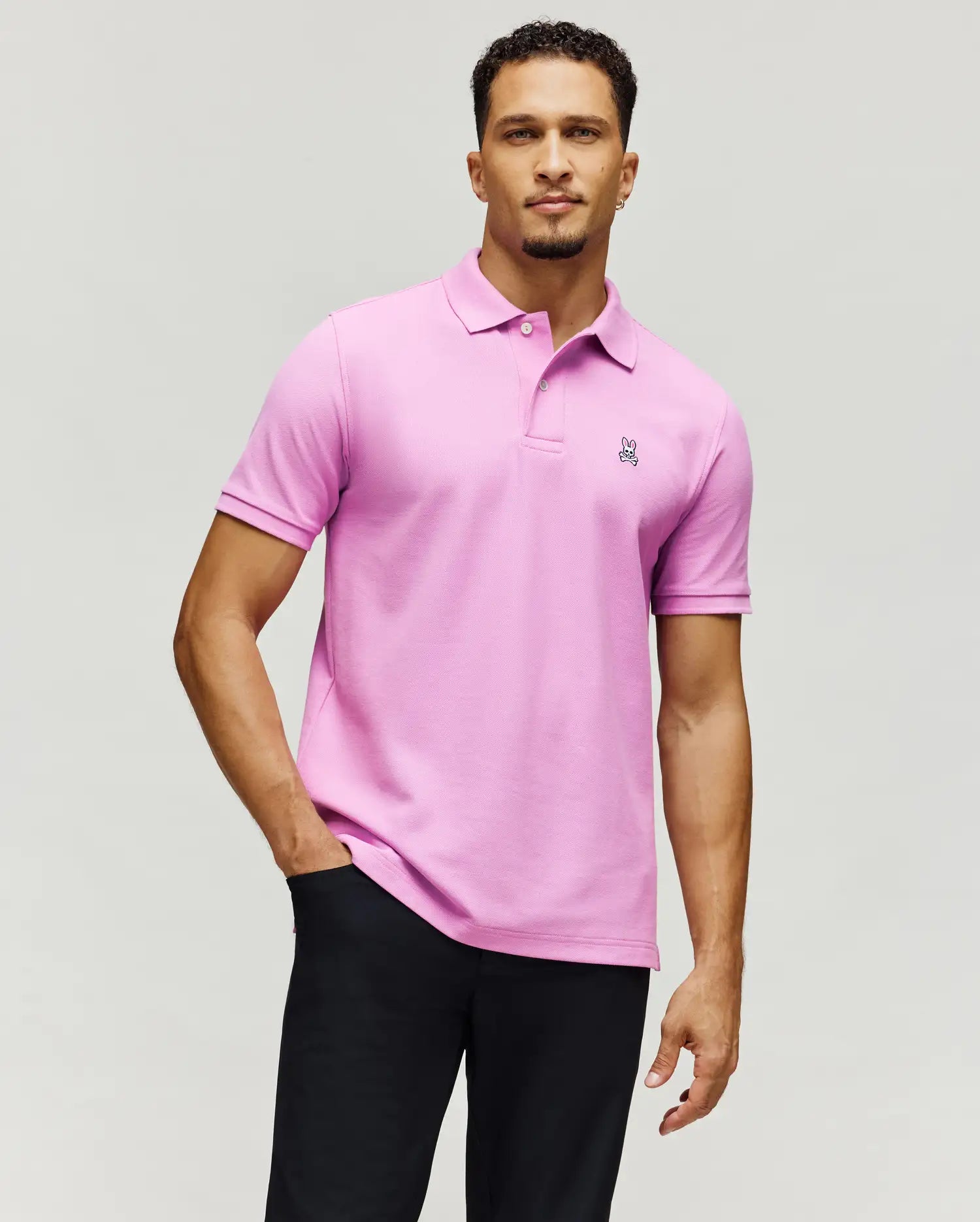 Pink Mens Classic Pique Polo, a refined streetwear staple with a classic fit, featuring a small embroidered Psycho Bunny skull logo on the left chest and two matching buttons.