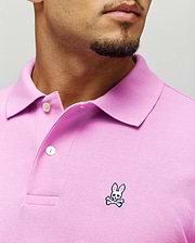 Mens Classic Pique Polo in vibrant pink pique fabric, featuring a classic fit, two white buttons, and a small embroidered Psycho Bunny skull logo with pink ears on the left chest.
