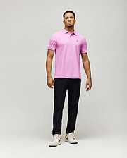 Mens Classic Pique Polo, a vibrant pink classic fit polo shirt crafted from textured pique fabric, featuring a small, intricately embroidered Psycho Bunny skull logo on the left chest.