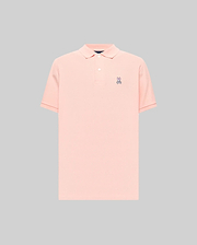 Mens Classic Pique Polo in peach, featuring a classic fit, pique knit texture, two-button placket, and a small embroidered purple, white, and black Psycho Bunny skull logo on the left chest with subtle red cuff tipping.