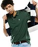 Mens Classic Pique Polo in forest green, classic fit, pique knit, with white buttons, a two-button placket, and a small embroidered pink and white Psycho Bunny skull logo on the left chest.